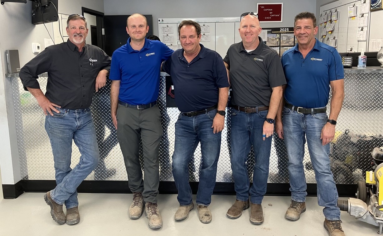 Some of our team members standing in front of the counter at a branch location.