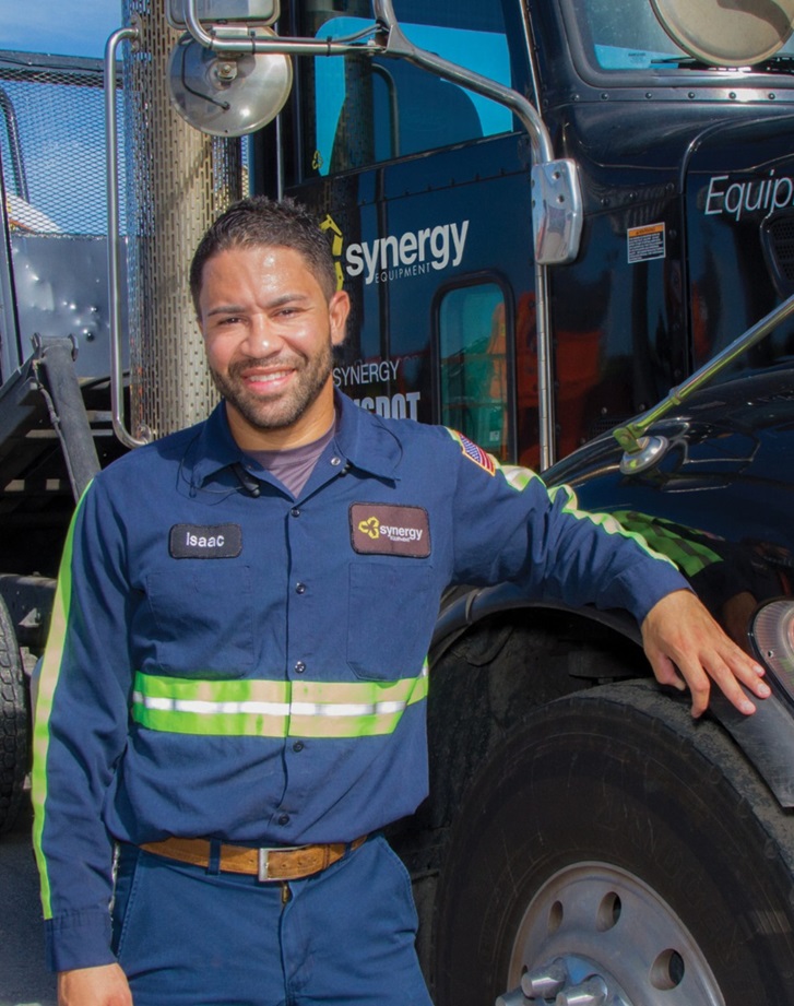 Truck driver, Isaac, standing next to his truck