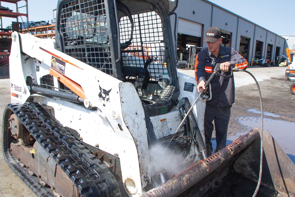 One of our teammates pressure washing a piece of equipment to get it ready for the next job