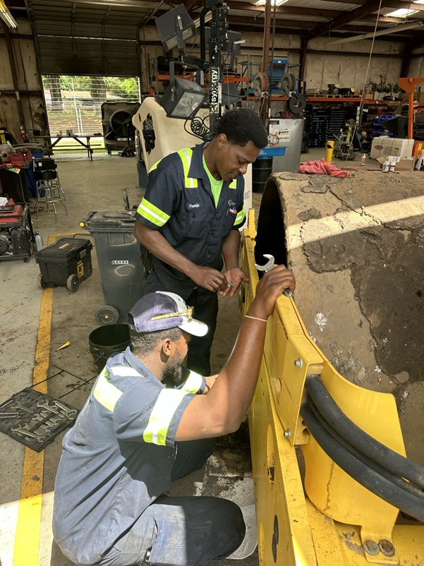 Two techs working on a machine