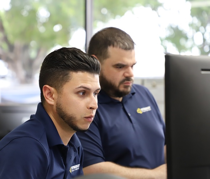 Two of our office workers at their computer