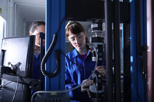 FCC employees operating a machine