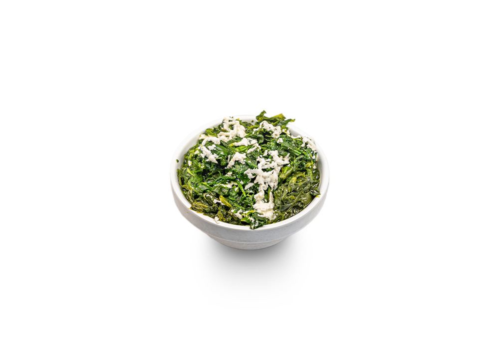 Sautéed spinach topped with crumbled white feta cheese