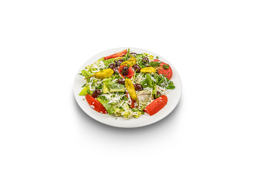 Lettuce salad topped with feta cheese cubes, olives, and tomatoes