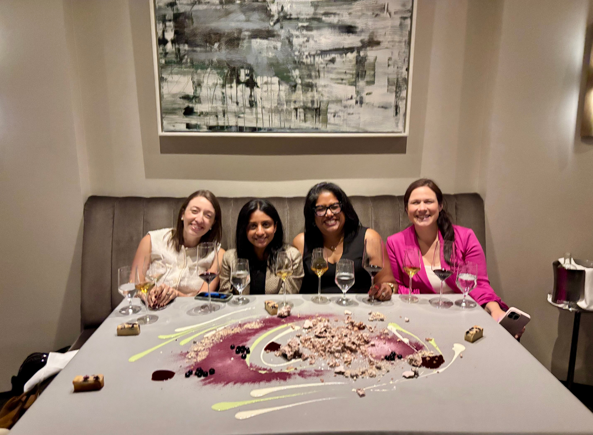 Four women enjoy a networking dinner at Alinea together after the Women in B2B event, sharing dessert and conversation.