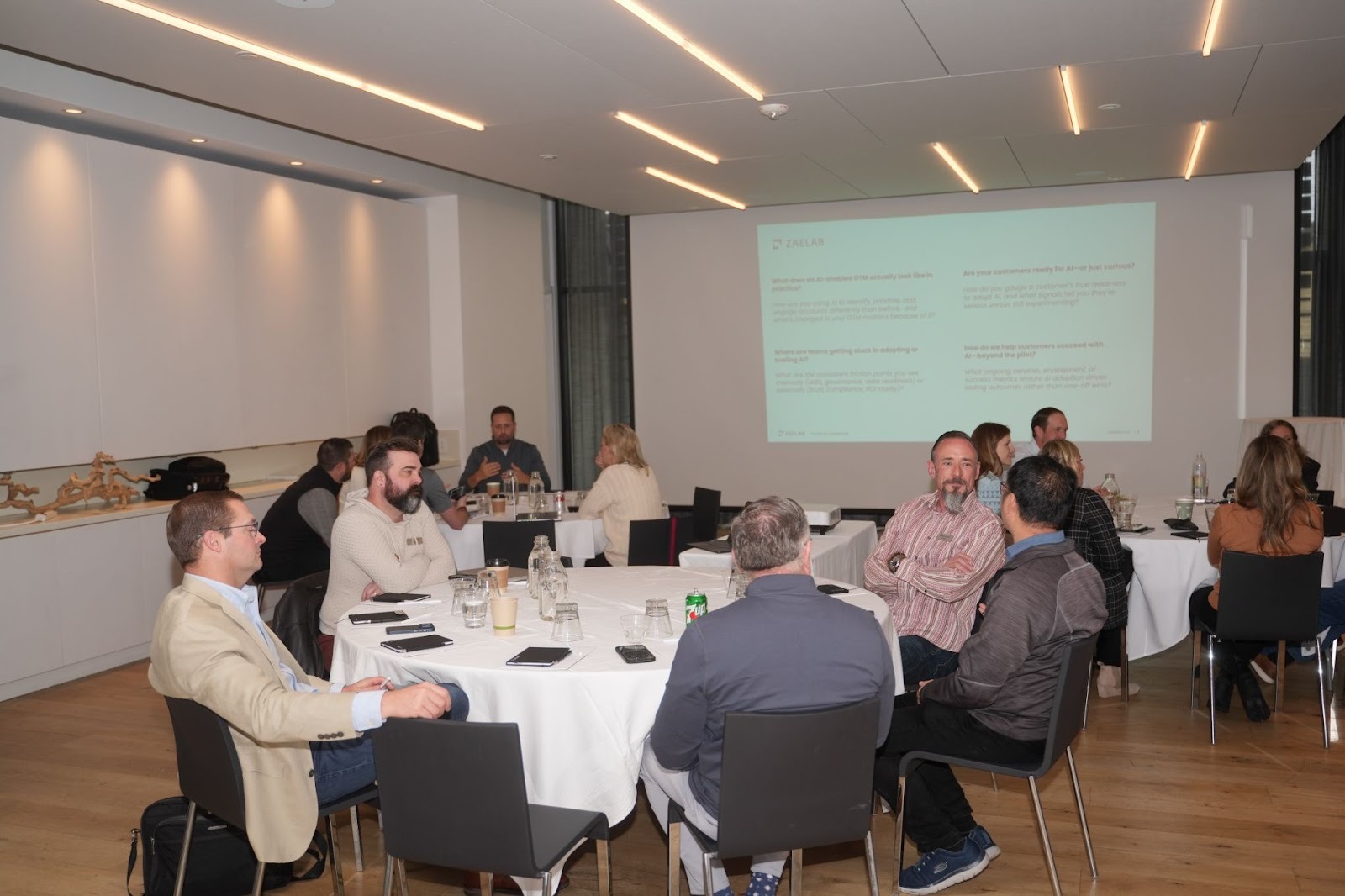 Attendees seated around round tables during a workshop session at the Better Together 2025 event in Sonoma, hosted by Zaelab in partnership with ServiceNow and Shopify.