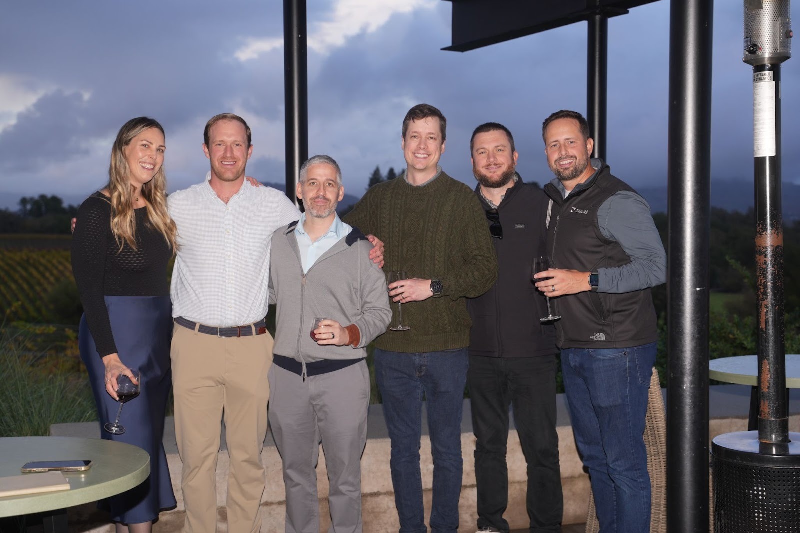 Group of six attendees smiling and posing together at sunset during the Better Together 2025 event in Sonoma, hosted by Zaelab in partnership with ServiceNow and Shopify.