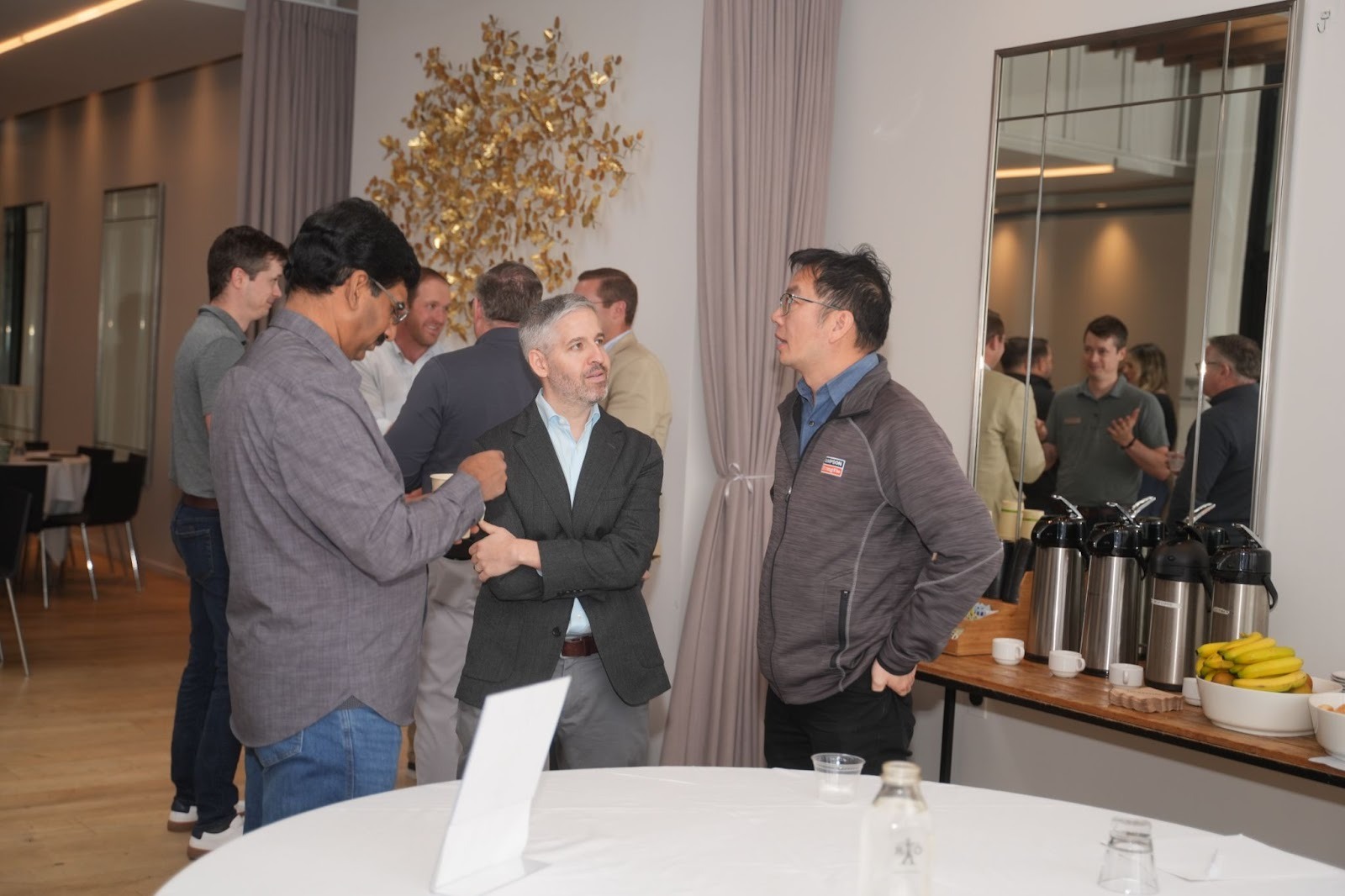 Attendees engaged in conversation during a coffee break at the Better Together 2025 event in Sonoma, hosted by Zaelab in partnership with ServiceNow and Shopify.
