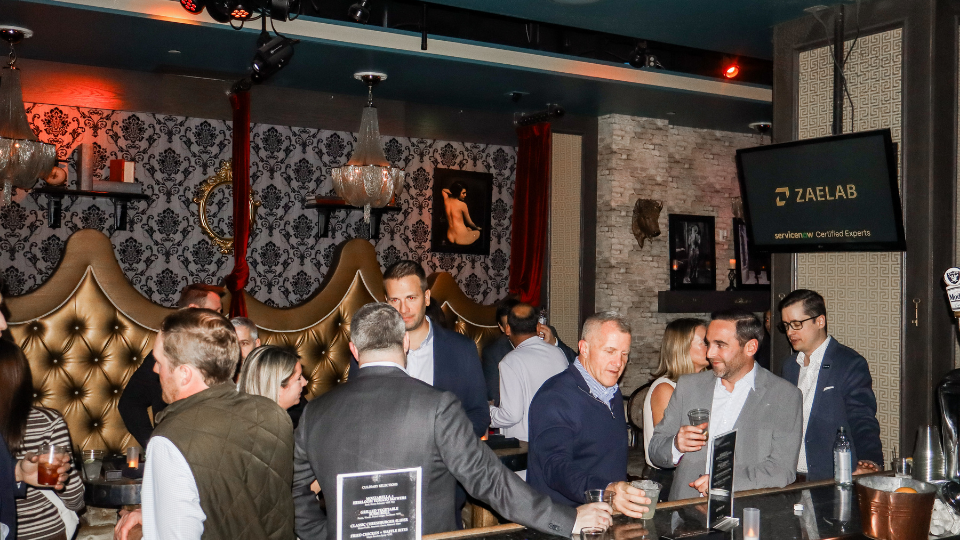 Attendees chatting at the ServiceNow SKO: After Dark event hosted by Zaelab