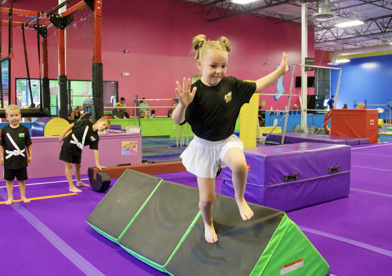 A young gymnast doing a cartwheel