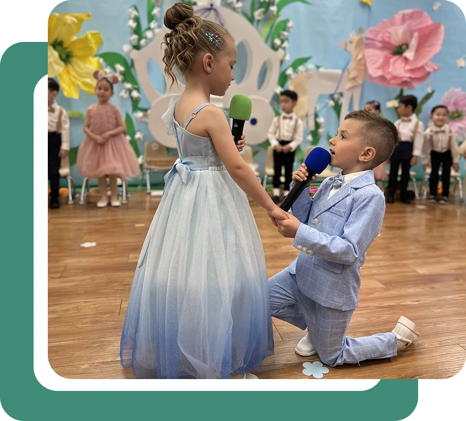 Children performing on stage at Children’s Land preschool, showcasing dance, creativity, and performing arts education.