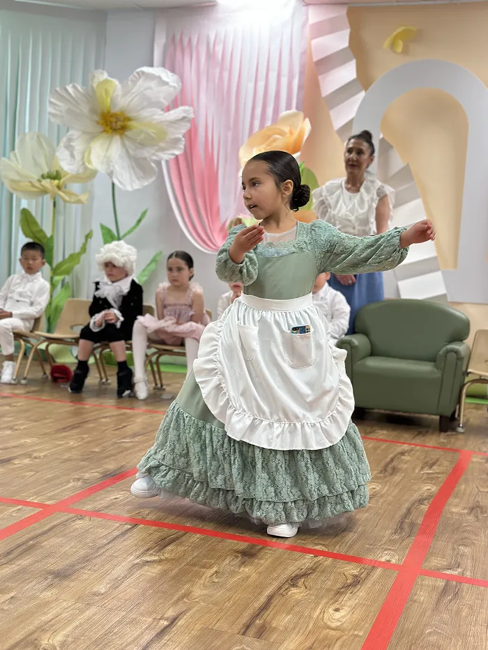 Preschool girl performing in costume during Children’s Land Broadway show.