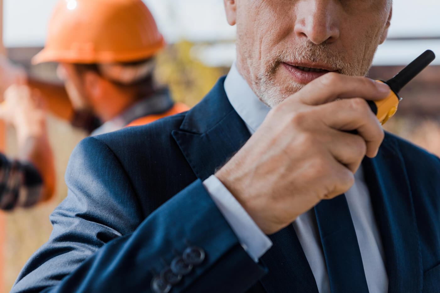 A man uses a walkie-talkie to communicate at volunteer event