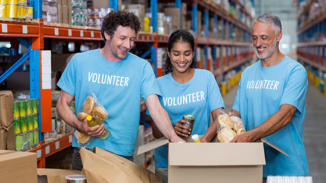 A man uses a walkie-talkie to communicate at volunteer event