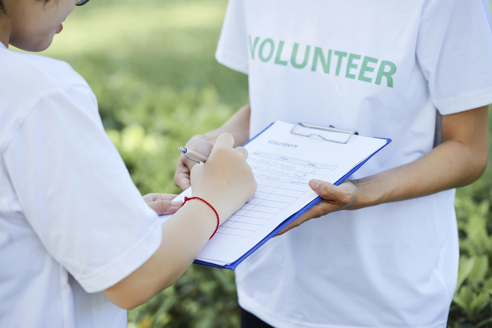 A man uses a walkie-talkie to communicate at volunteer event