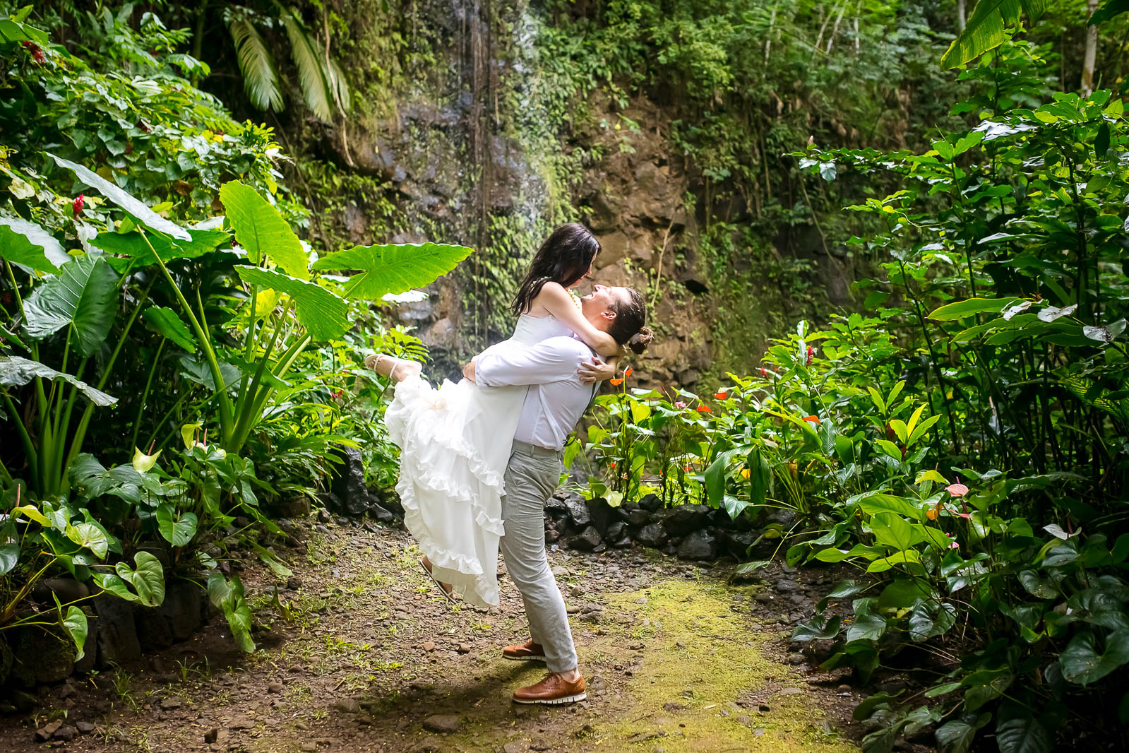 Groom picks up his bride in joy