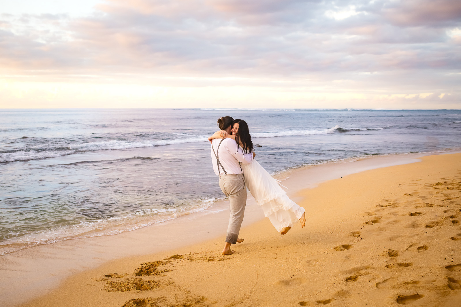 Groom playfully twirls his bride