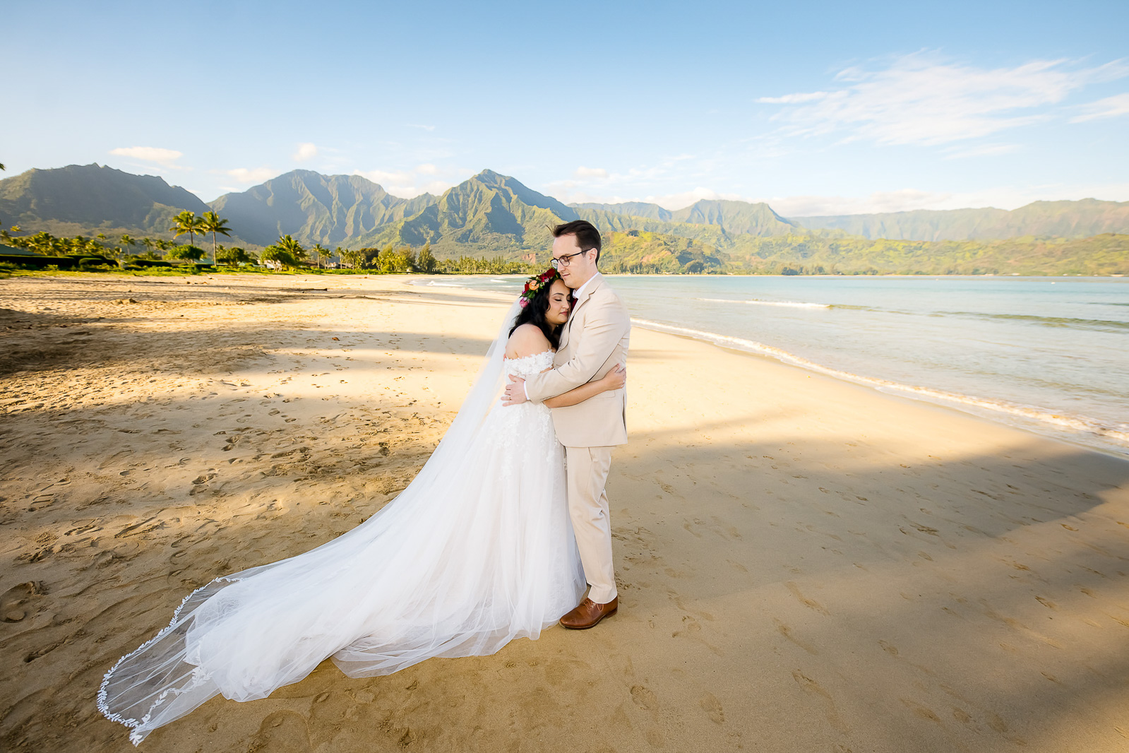 Bride and groom share a hug after their Kauai beach elopement.