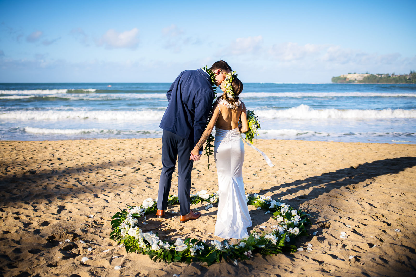 kauai elopement bride and groom in flower circle on beach in north shore