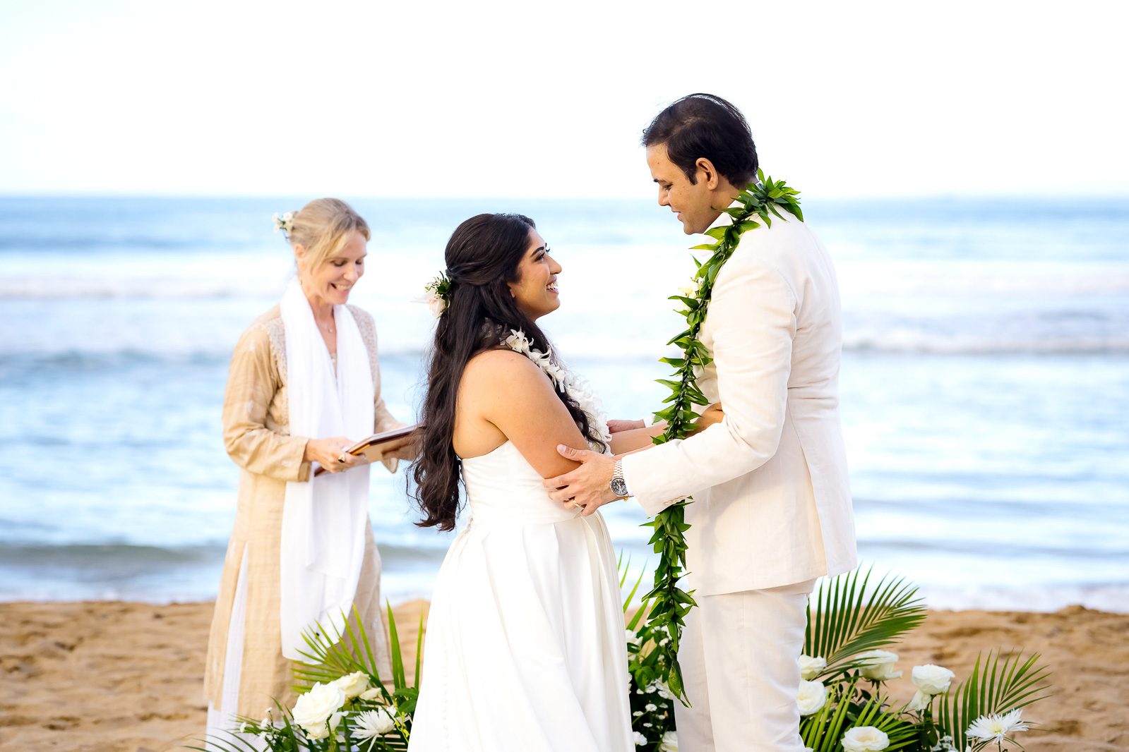 elopement wedding  officiant and planner with bride and groom on beach in kauai