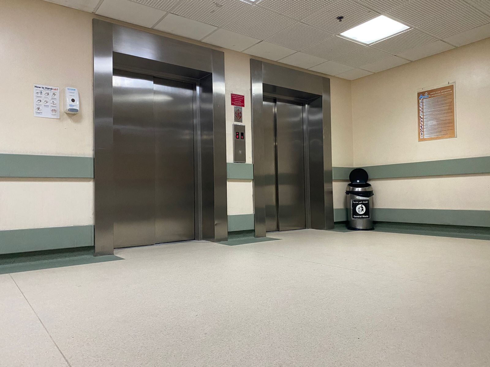 External hidden step lift recessed into the floor outside a hotel. The step lift provides wheelchair access to the main entrance
