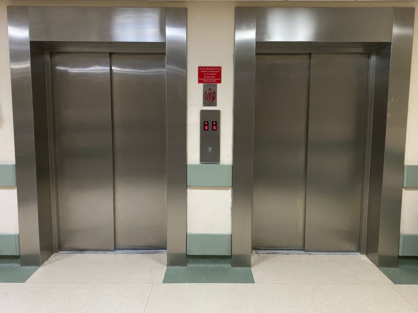 Step lift sited in a rustic brick lift shaft. The wheelchair access lift is finished with fully glazed side panels and black painted steel