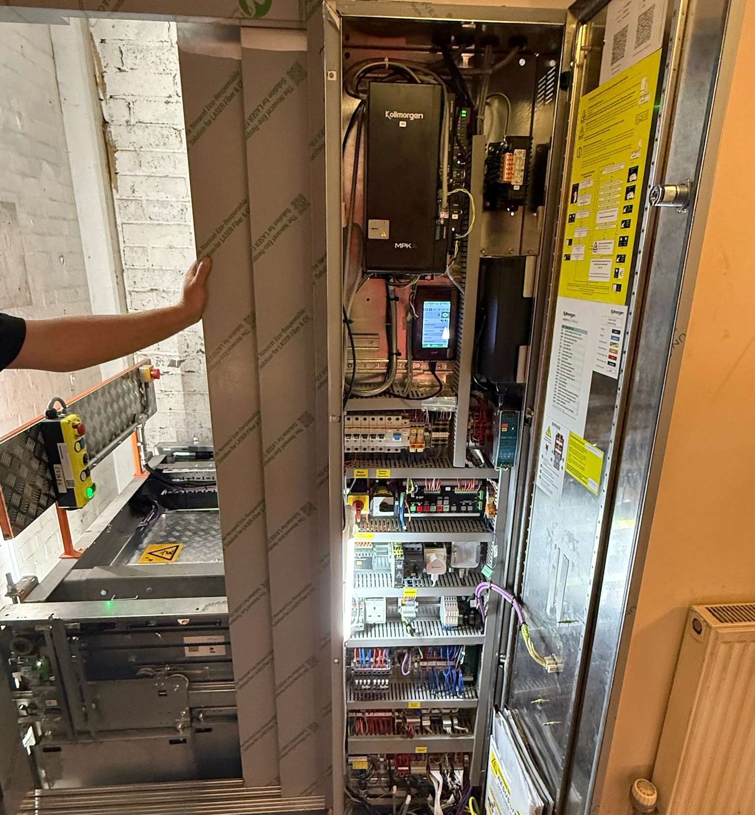 Old lift upgraded with an oak panelled lift car with bronze stainless steel control panel during the lift modernisation