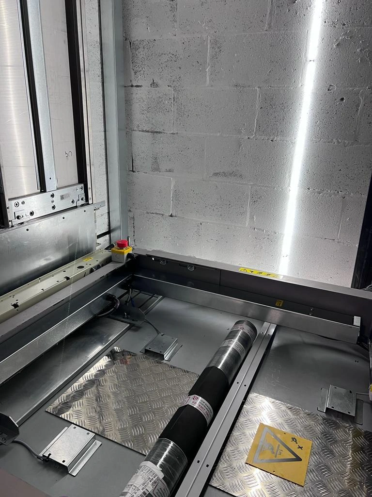 Regular cleaning of a passenger lift during lift maintenance is vital to component longevity, the lift car top is gleaming