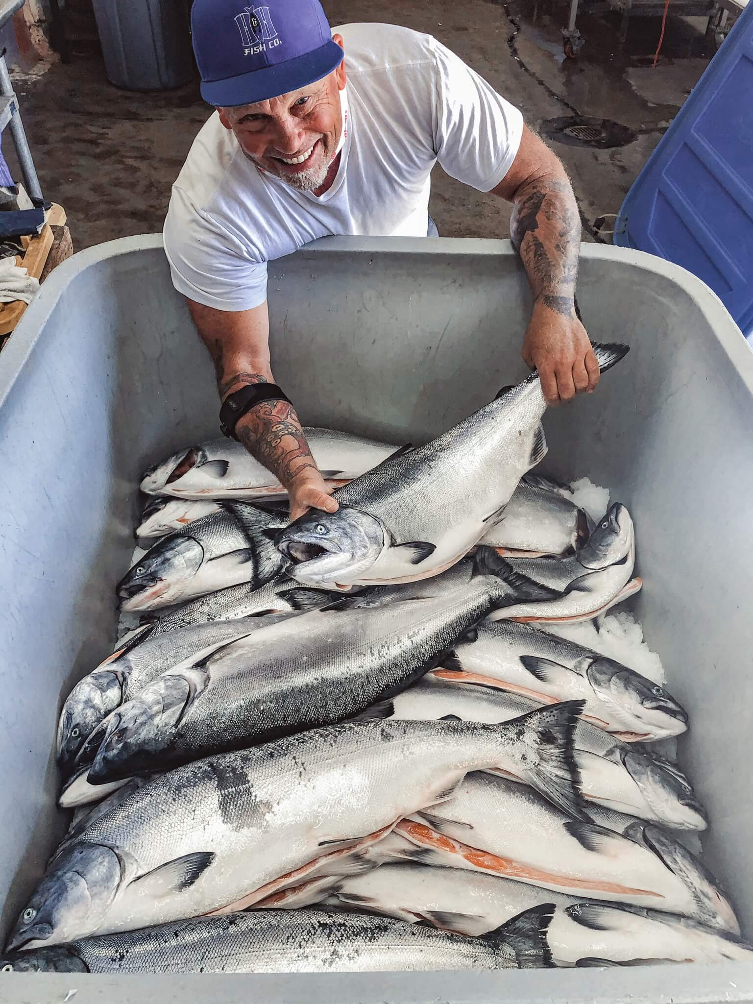 Hans (co-owner of H&H Fresh Fish) hold whole king salmon