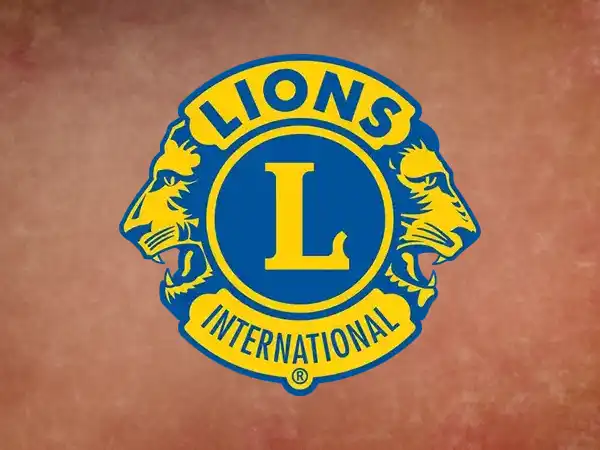 Lions Club International logo featuring a bold blue and yellow design with two lion profiles facing opposite directions and a large "L" in the center.