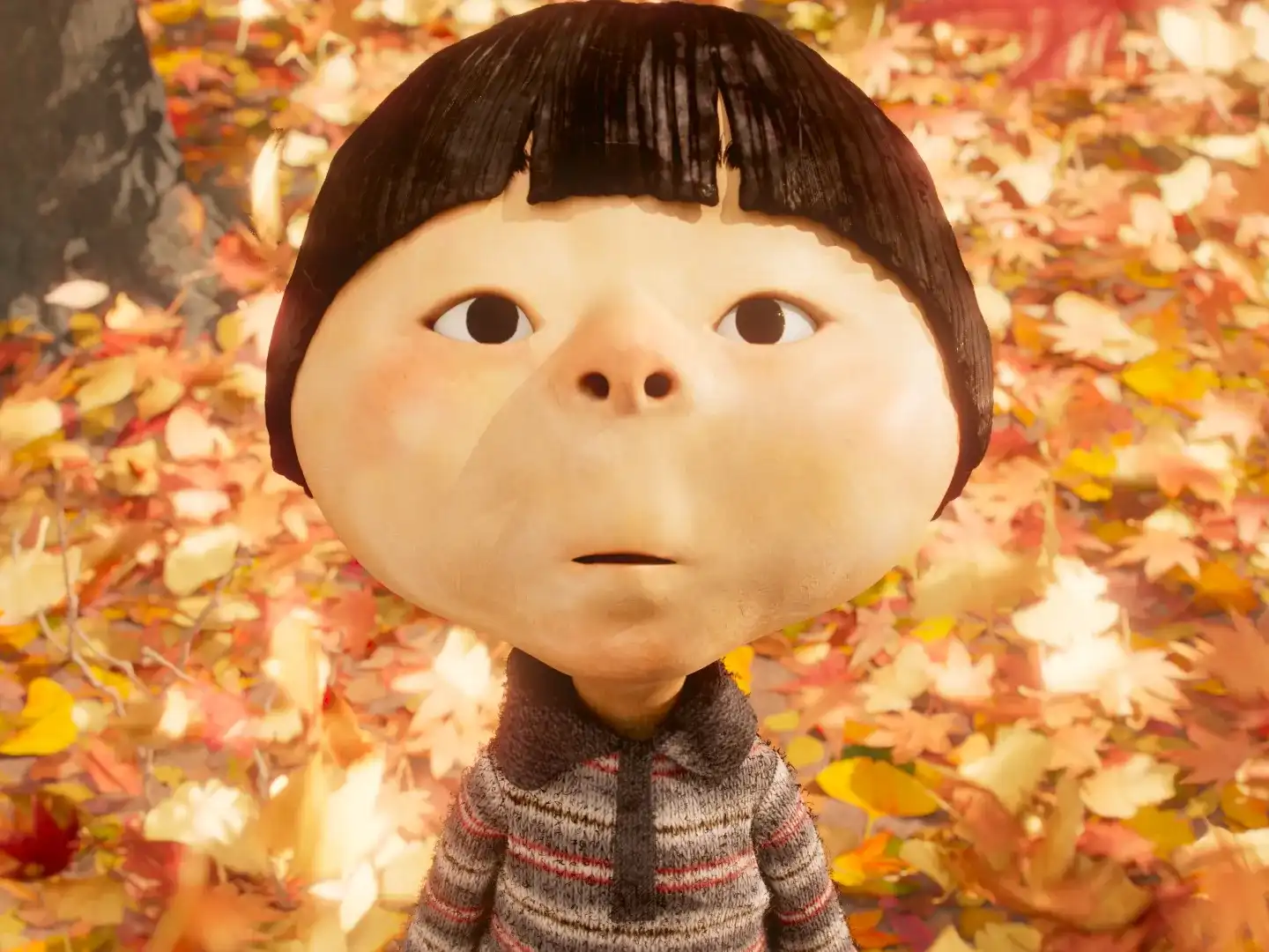 A close-up of a child with a surprised expression in a stop-motion animated film, surrounded by fallen autumn leaves.