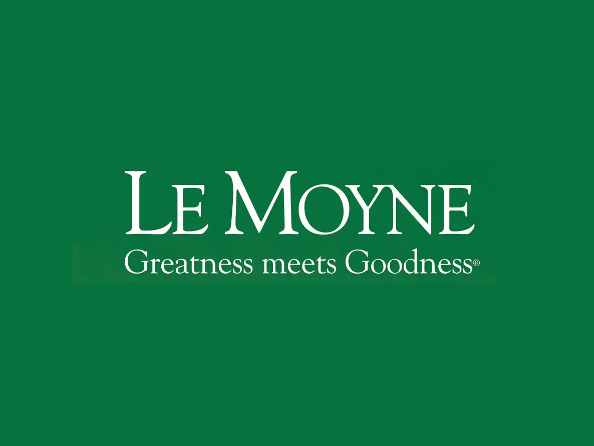 White Le Moyne College logo featuring the text "Greatness meets Goodness" centered on a solid green background