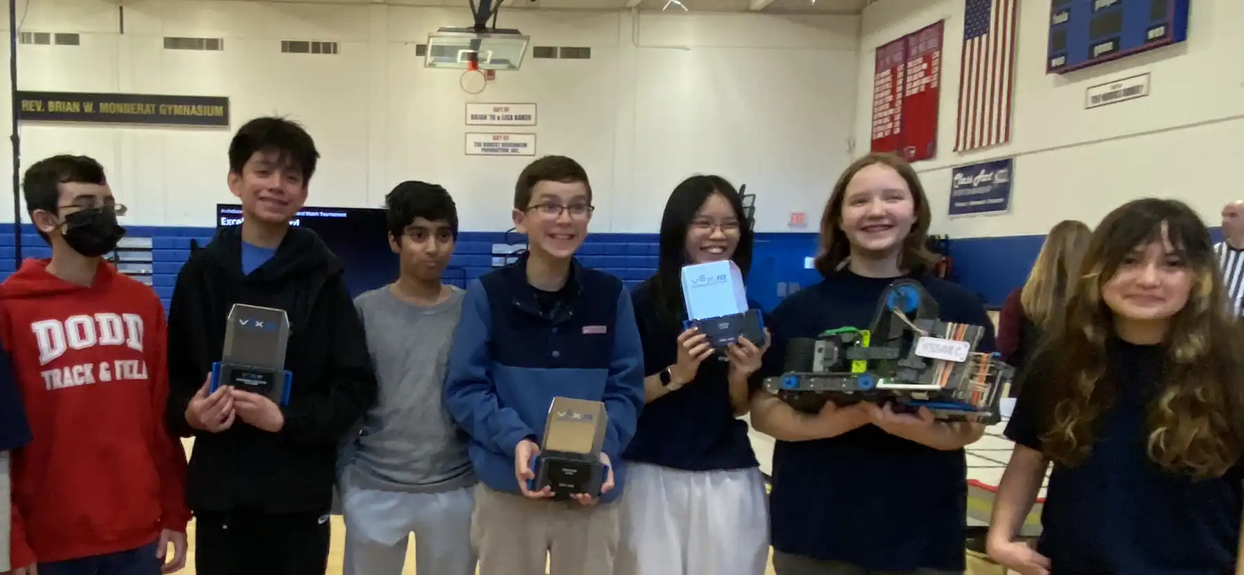 CT STEM Academy's Lee Parsons, Rodrigo Juarez, River Vora, Max Ulbrich, Sophia Wong, Victoria Cyr, and Cathleen Barnes celebrate their VEX IQ Robotics success.