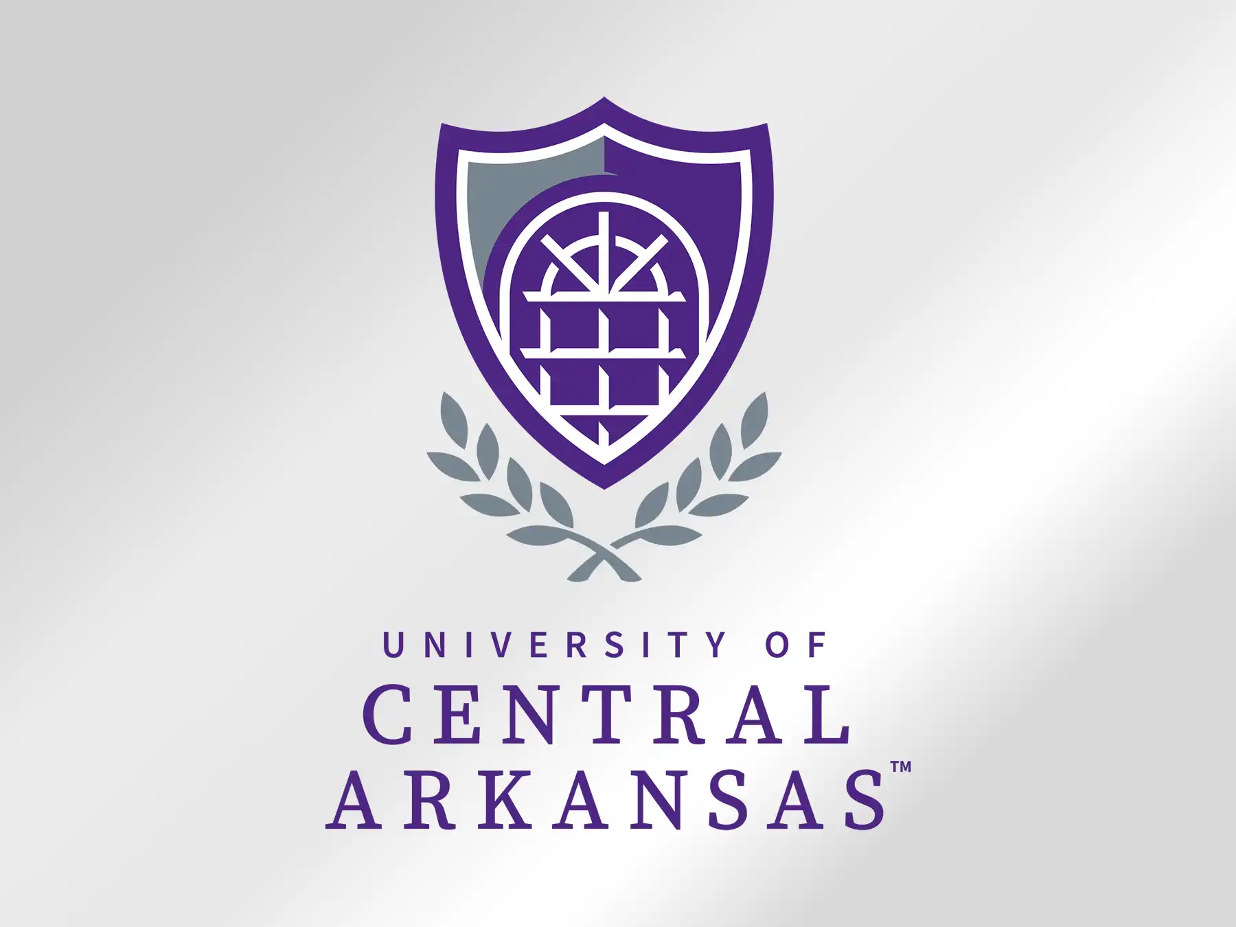 Official University of Central Arkansas logo featuring a purple and gray shield emblem with laurel leaves above the university wordmark.