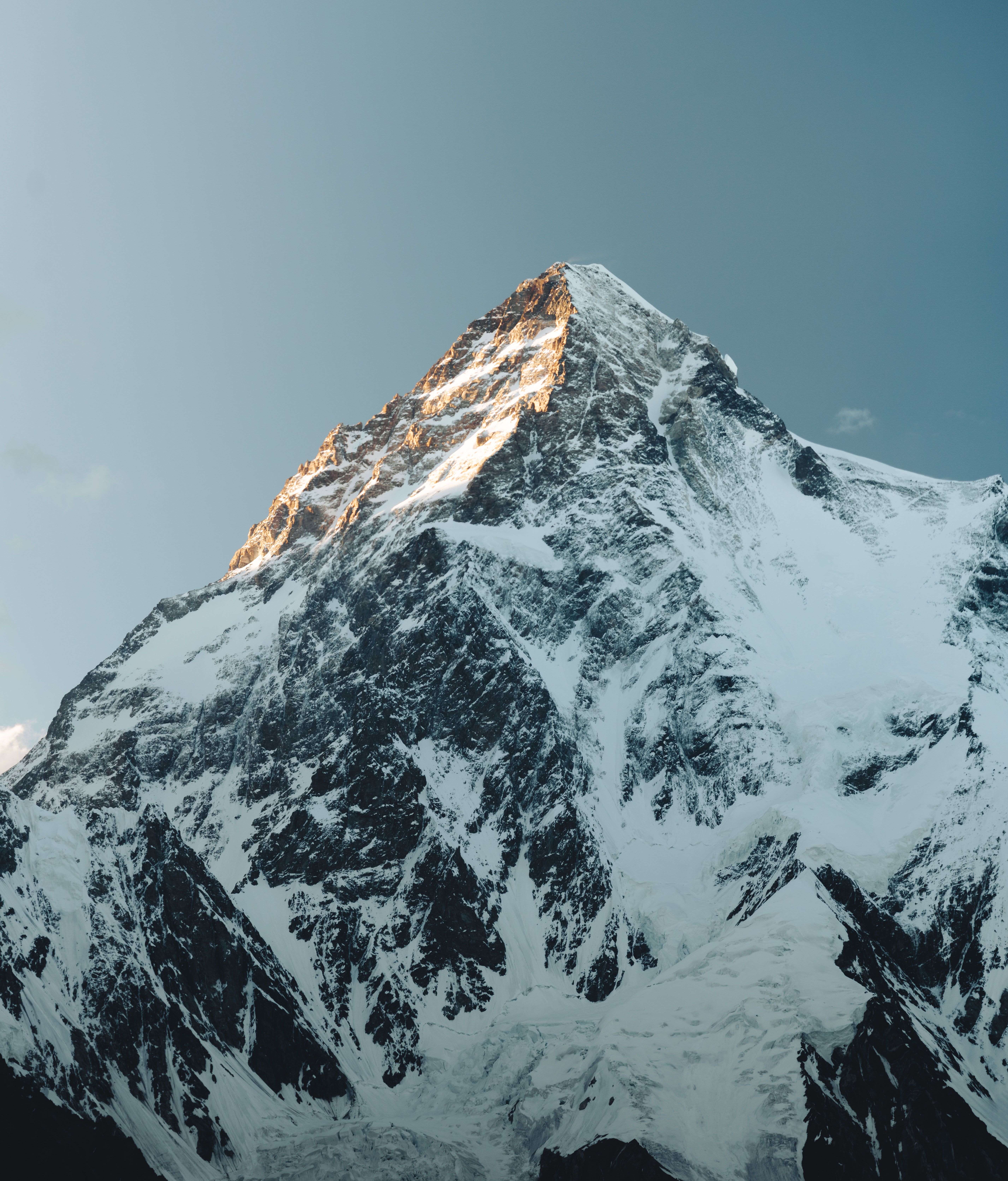 K2 Mountain emerging from a sea of ice and snow, calm blue hour atmosphere