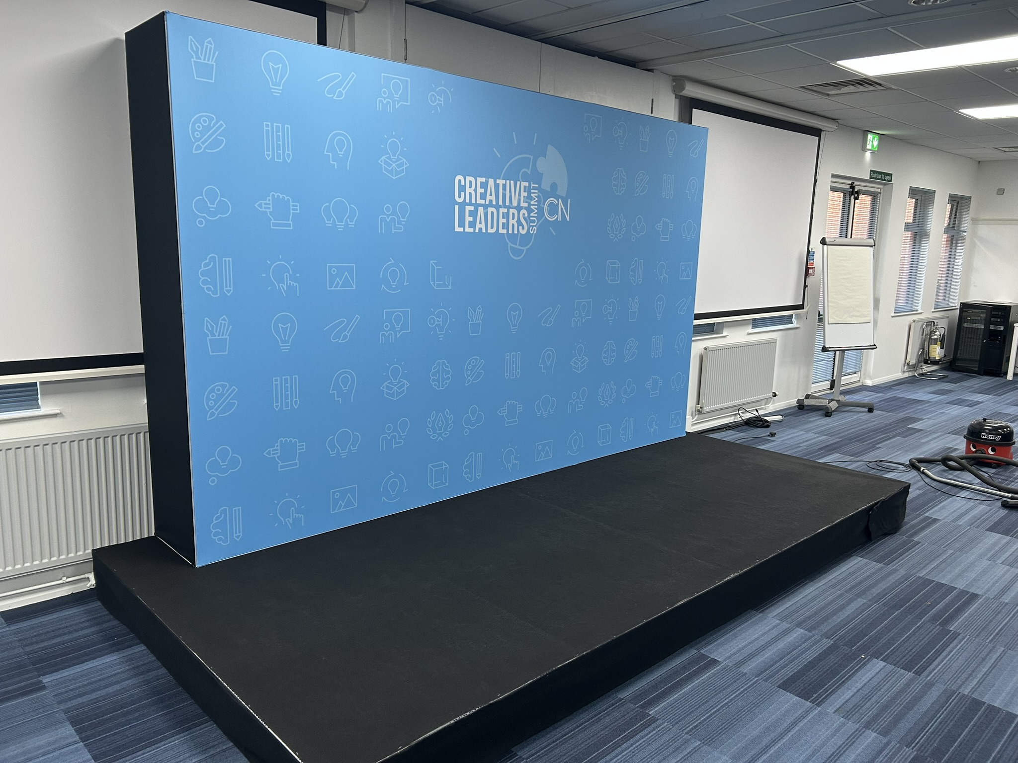 Blue Step and repeat wall used as a stage backdrop 3.6m wide at a golf course