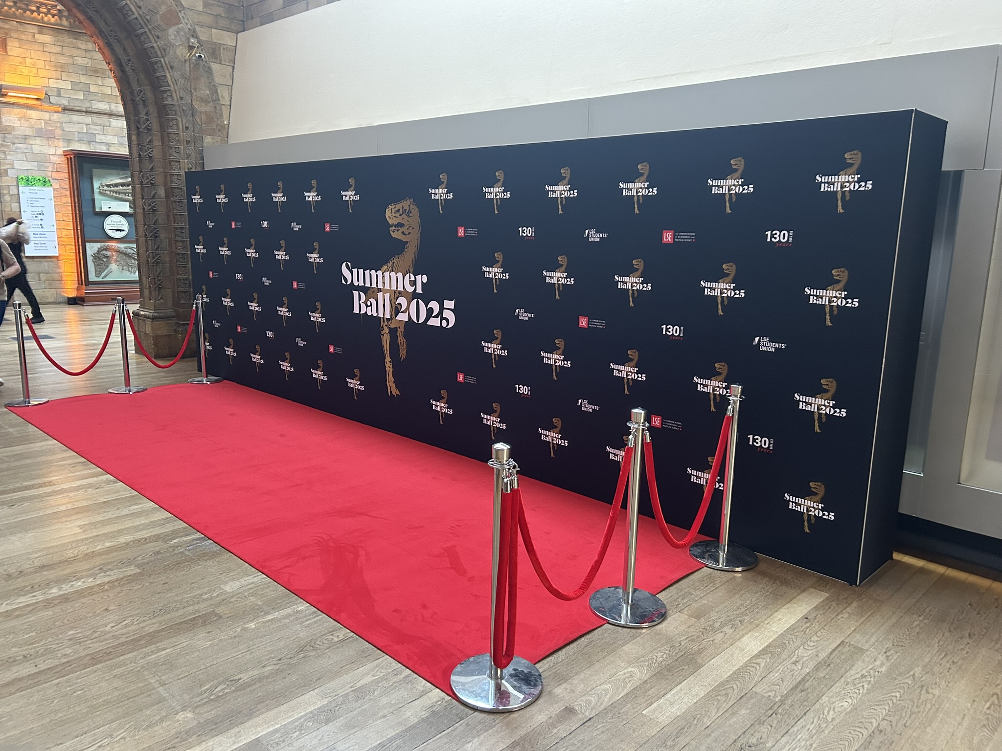 Red carpet and rope barriers with a 7.2m wide step and repeat wall at the natural history museum london