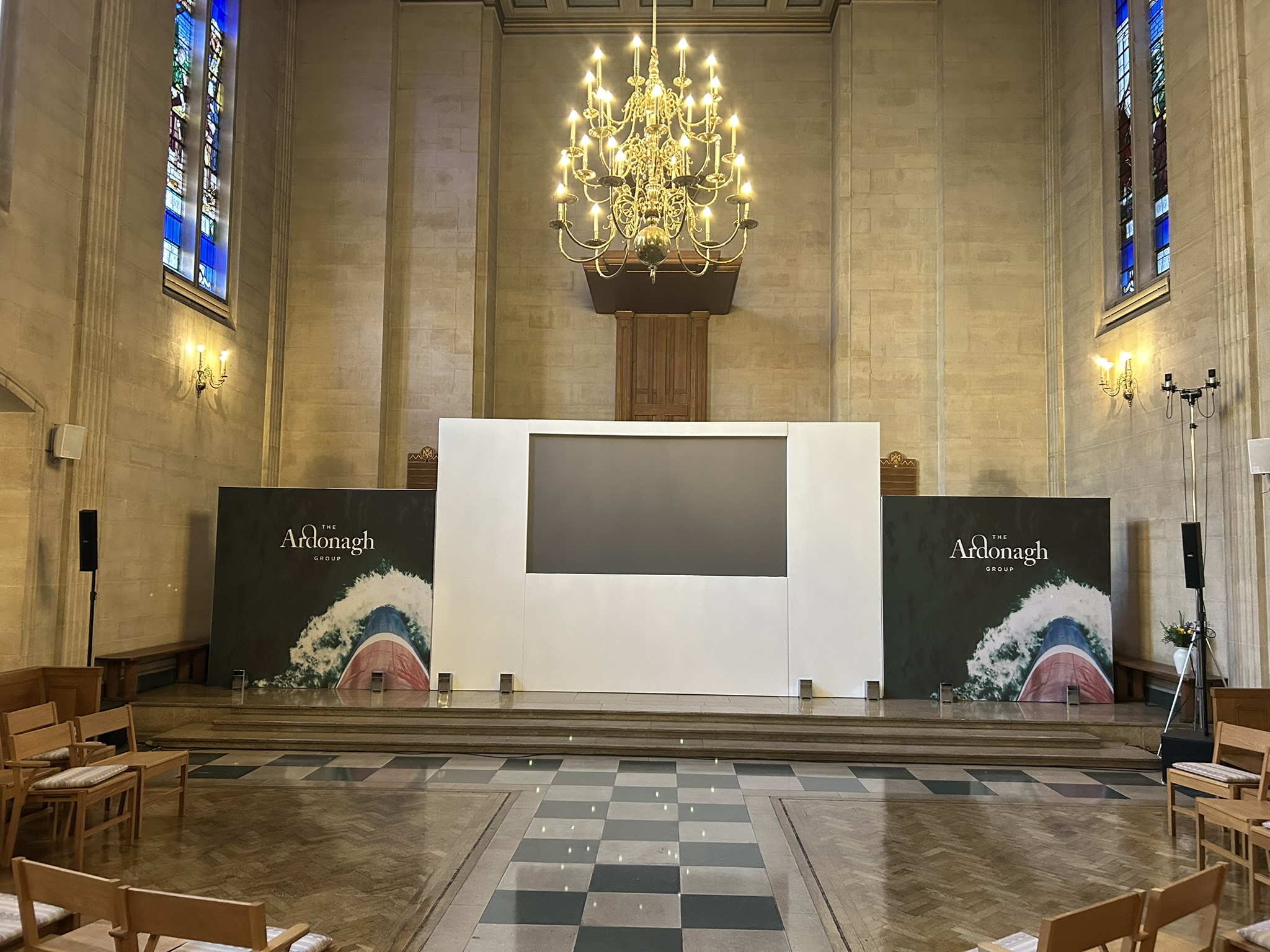 Two branded side backdrops to main presentation projector screen