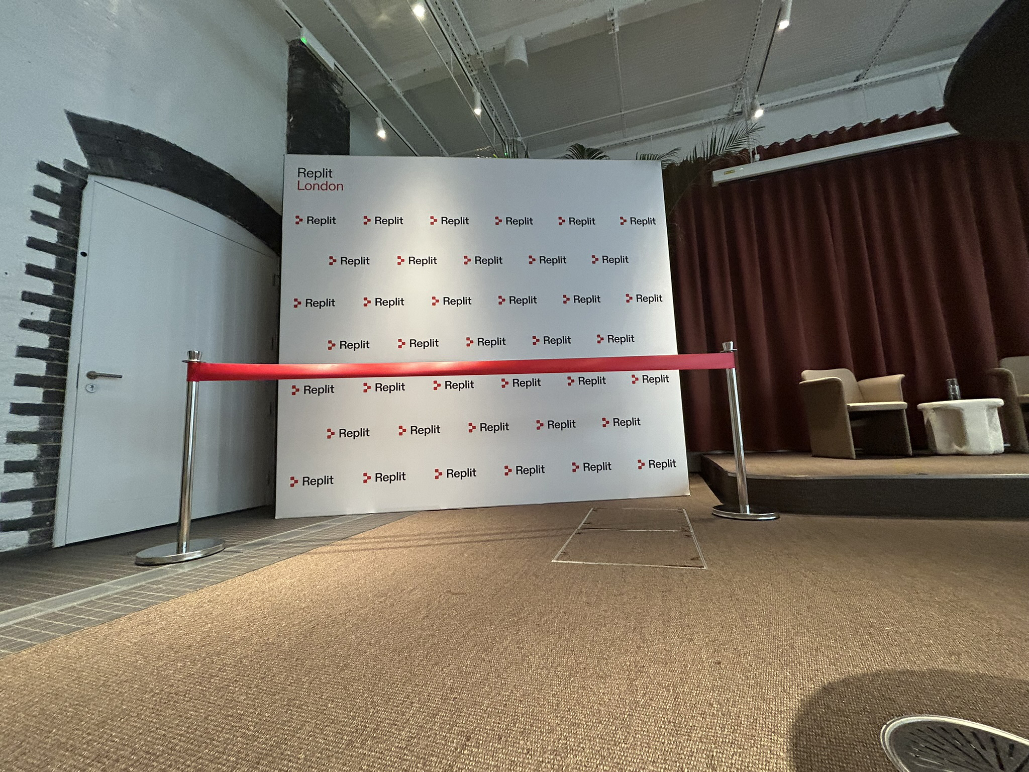 post and ribbon with a branded backdrop for a ribbon cutting ceremony