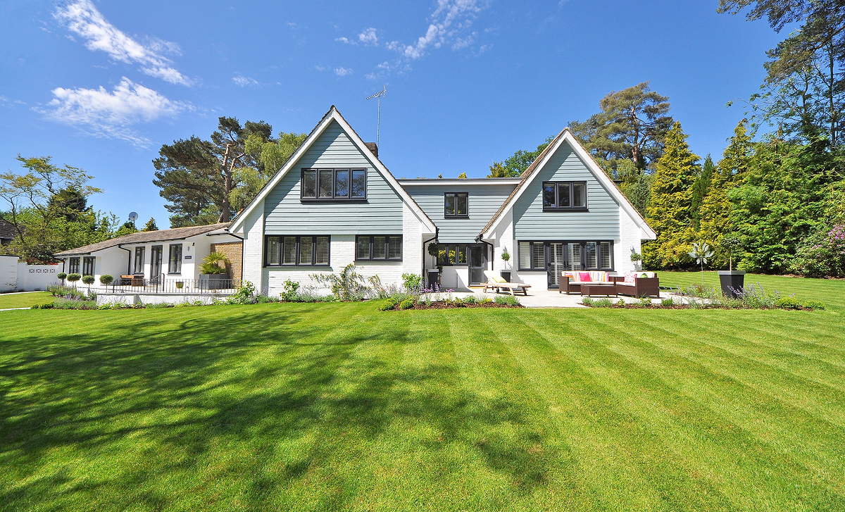 Coastal cottage with blue-gray board and batten siding and white trim