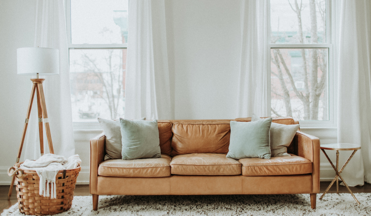 Living room with tall windows and sheer white curtains filtering natural light