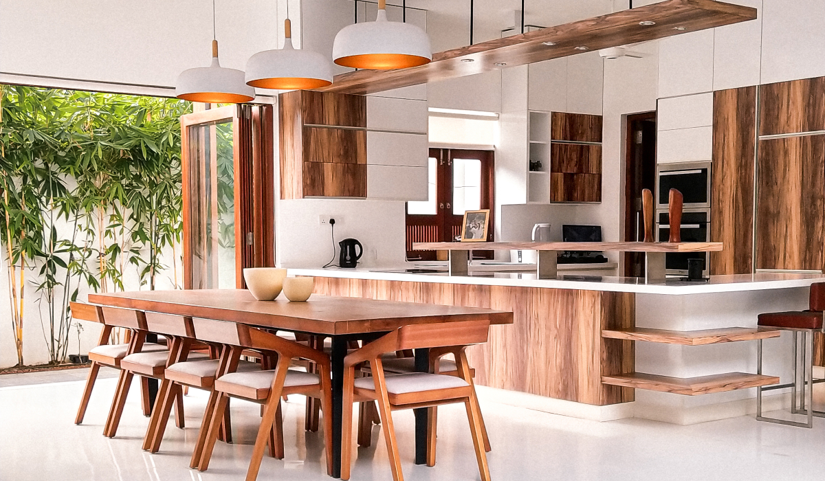 Open-concept kitchen and dining area with wide glass doors letting in natural light