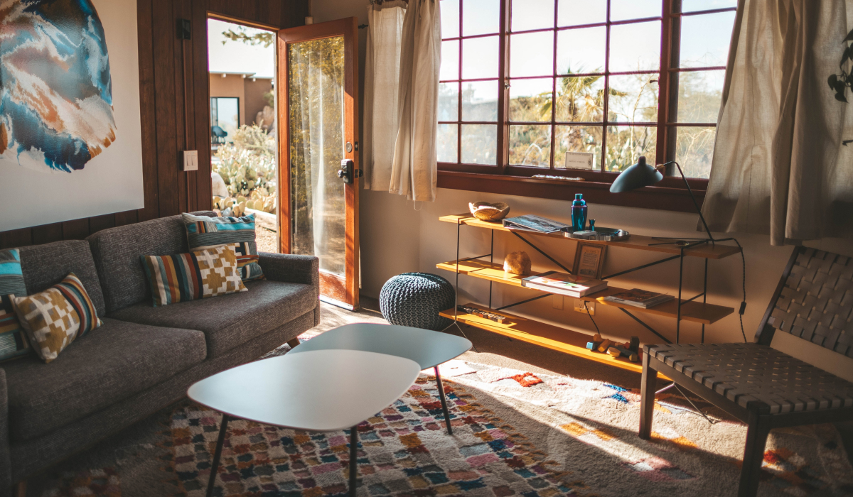 Cozy living room with an open door and large window filling the space with sunlight