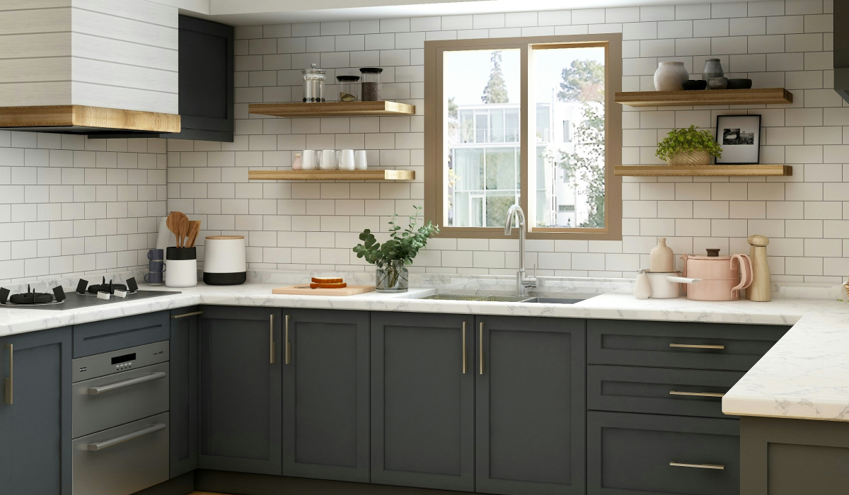 Modern kitchen with dark gray shaker cabinets, white subway tile backsplash, marble countertops, floating wood shelves, and a window above the sink framed in wood trim.