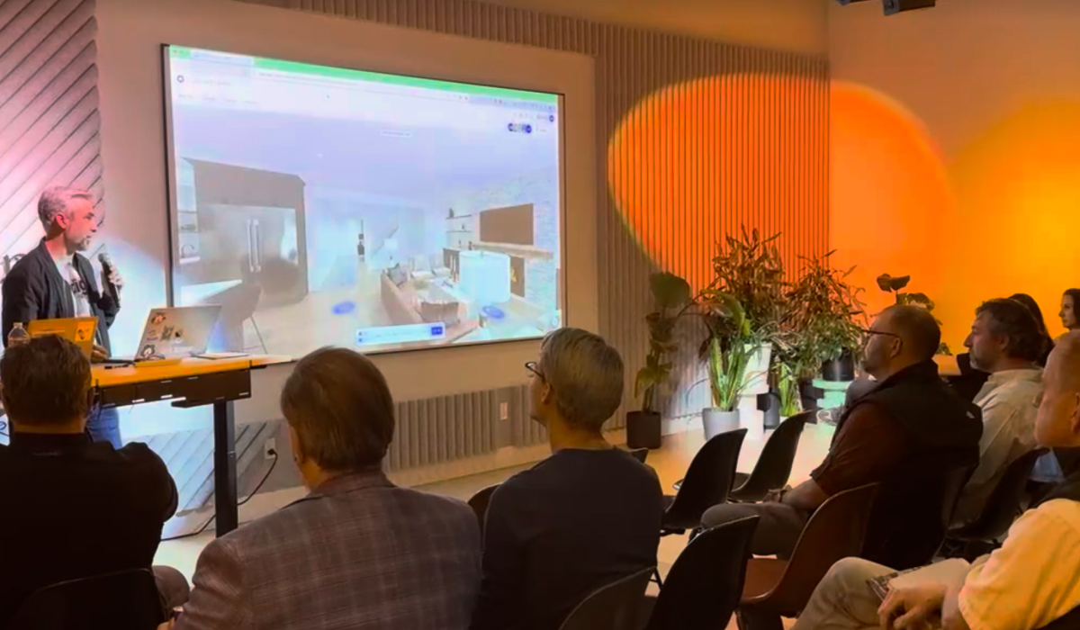 Digs CTO Jason Goetz presenting a live product demo at Portland Startup Week, with a 3D home design tool displayed on screen for a seated audience.