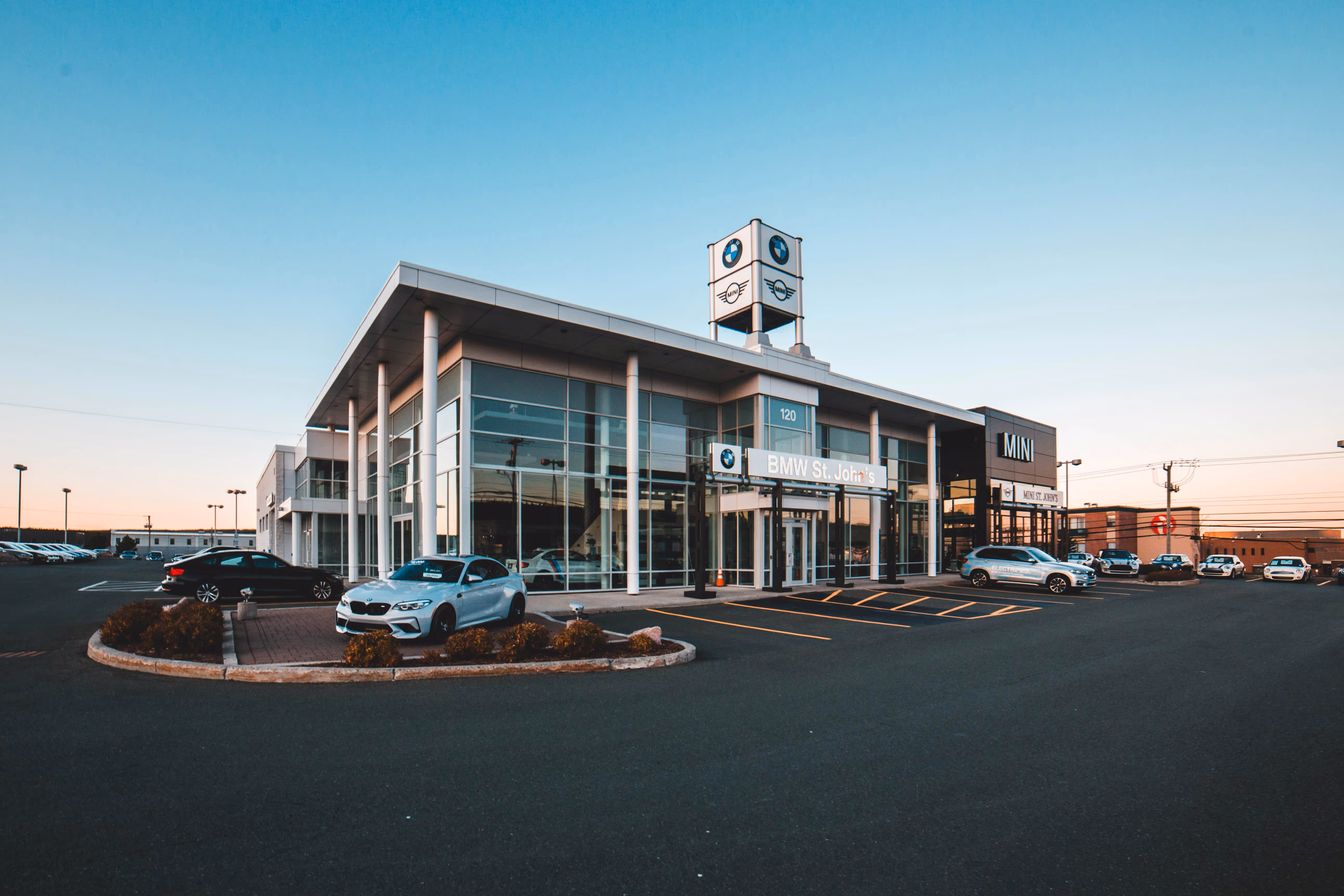 Exterior sunrise shot of a BMW dealership., image