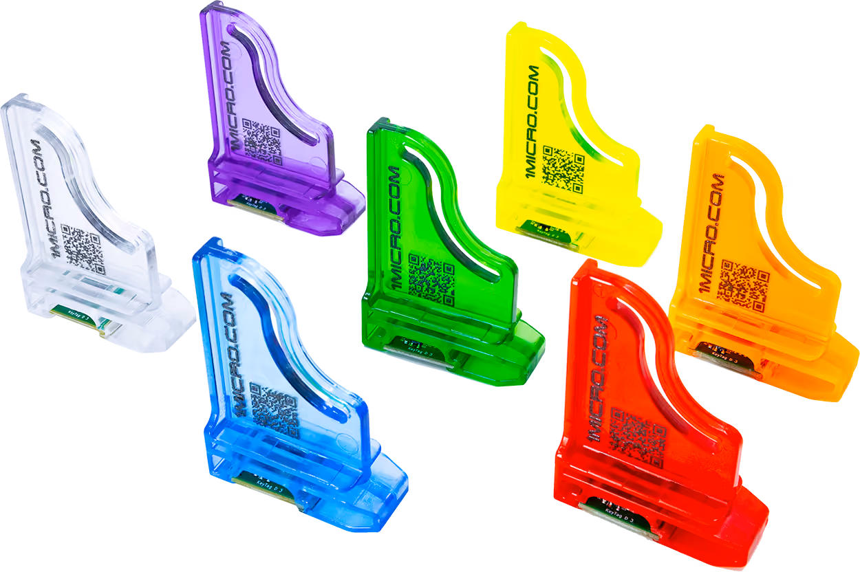 Seven 1Micro KeyTags in colors: clear, purple, blue, green, yellow, orange, and red.