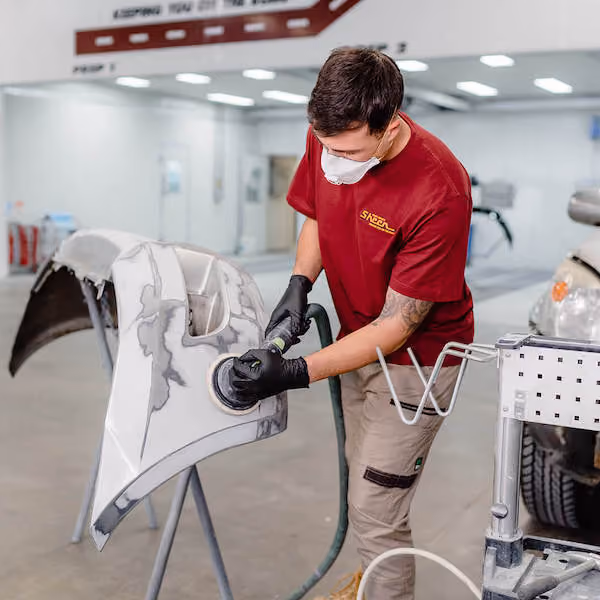 Interior workshop scene at Sheen Panel, featuring technicians at work.