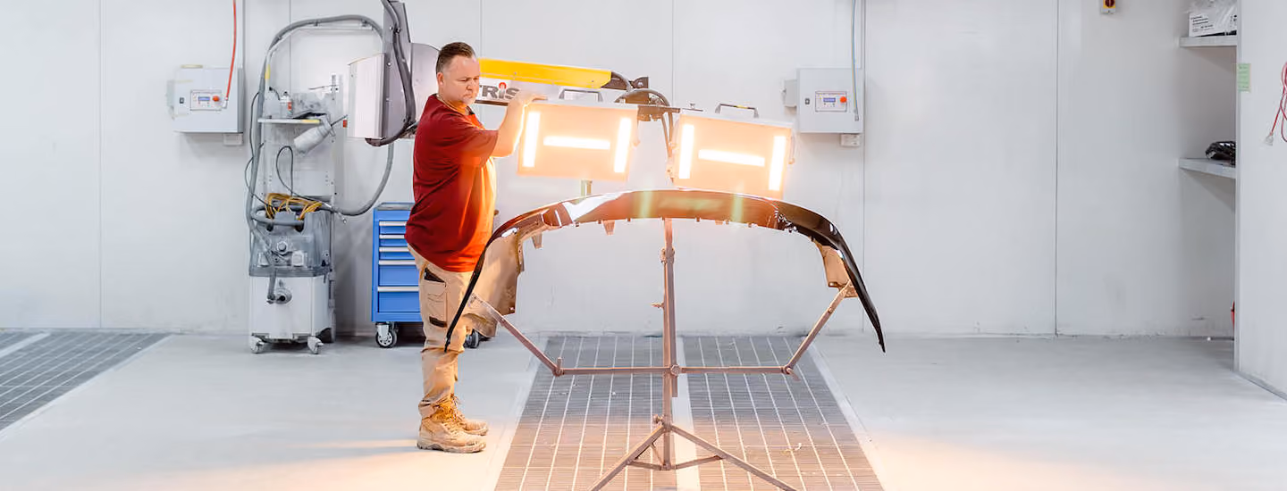 Sheen worker using heated equipment for repairs. 