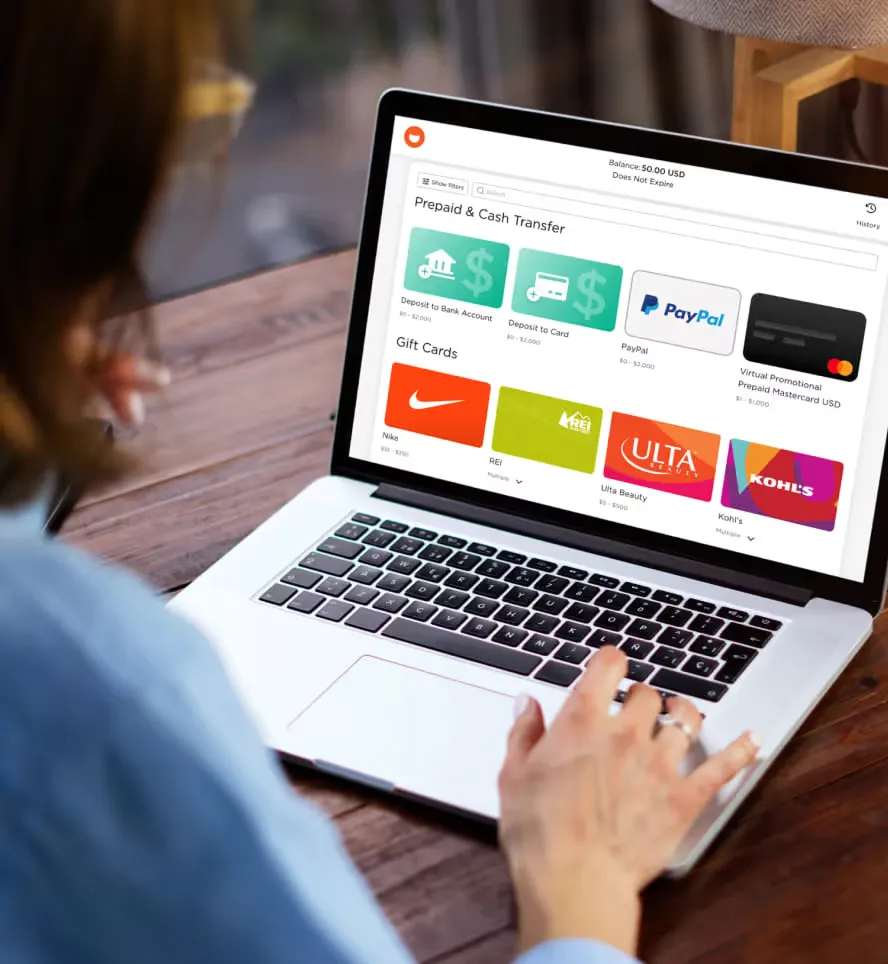 A person on their computer displaying the disbursement link page which features gift cards.